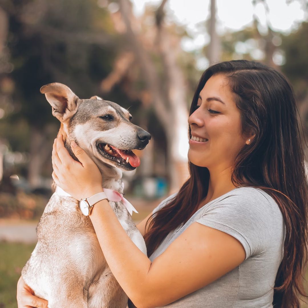 A woman playing with dog.