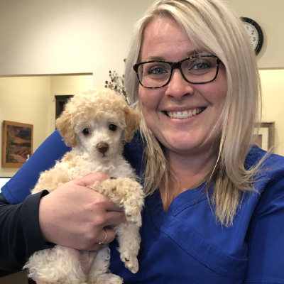 woman holding a puppy